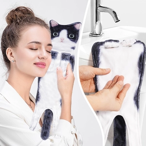 Detail showing soft microfiber texture of black and white cat hand towel on face and sink