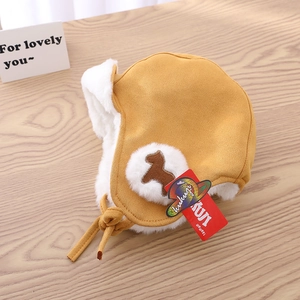 Detail of toddler ginger yellow trapper hat with soft white plush lining and ties
