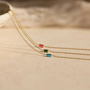 Macro detail of gold stainless steel bracelet with colorful square cut zircon stones