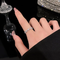 Detailed view of silver rings featuring micro-set cubic zirconia in floral patterns