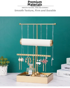 Three-tier gold jewelry stand featuring white velvet bars and a marble-patterned base