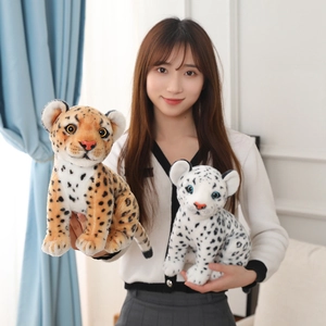 Detail of plush snow leopard and leopard toys showing realistic fur and plastic eyes