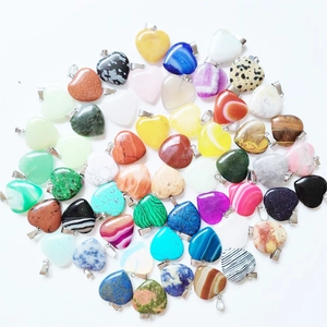 Assorted heart-shaped gemstone pendants with metal bails in various natural stone colors