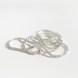 Minimalist S925 sterling silver textured rings stacked on a clean white background