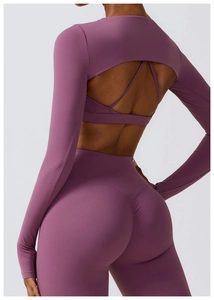 Détail d'un ensemble de yoga violet avec haut ajouré et legging à taille haute