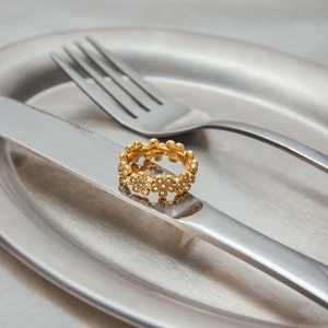 Detailed macro view of 18K gold plated stainless steel flower ring with zircon stones