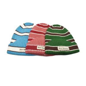 Striped knit beanie hats in multiple colors with woven labels for men and women