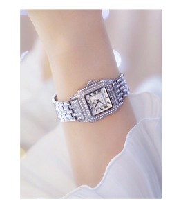 Detail shot of silver square quartz watch featuring crystal-encrusted bezel and band