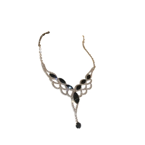 Silver fringe necklace set with black gemstones and crystals on white background