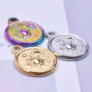 Macro shot of sun and moon engraved pendants in gold, silver and rainbow finishes