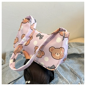 Close-up of purple canvas shoulder bag featuring cute cartoon bears and white polka dots