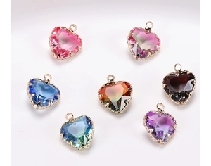 Macro view of heart-shaped crystal pendants with gradient colors and gold plated edges