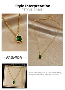 Detailed macro view of an emerald green square pendant on a gold stainless steel chain