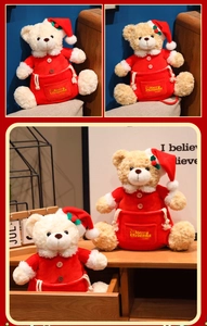 Close-up of Merry Christmas embroidery on plush teddy bear gift bag with soft red velvet