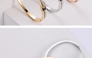 Detailed view of square black stones and pavé cubic zirconia on triple-color bangles