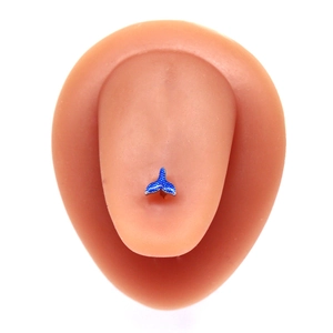 Detailed view of a blue whale tail stud earring on a silicone model with silver texture