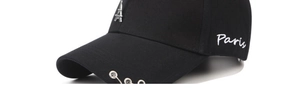 Detail of black cotton cap with silver rings and Eiffel Tower metal pendant charm