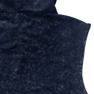 Close-up of dark blue acid wash fabric texture and stitching on men's sleeveless hoodie