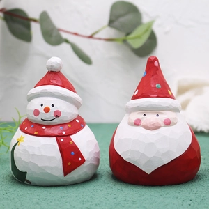 Handcrafted wooden Christmas Santa and snowman figurines for festive tabletop decoration