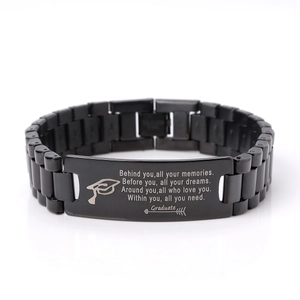 Macro view of black stainless steel graduation bracelet with inspirational quote engraving