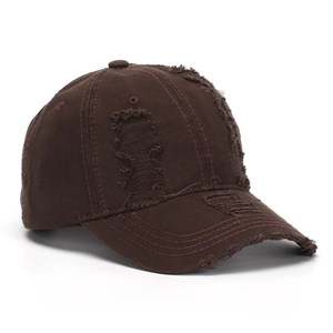 Close-up of distressed vintage denim baseball cap with worn holes and washed finish