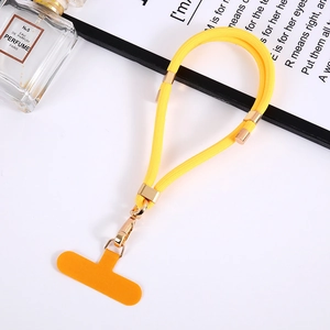 Macro shot of yellow braided phone lanyard with gold metal buckle and orange patch
