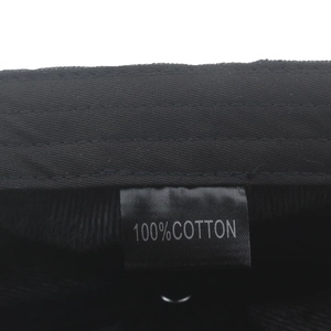 Detail shot of the newsboy cap interior showing the 100% cotton label and twill fabric