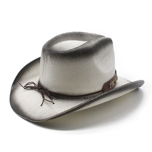 Detail of vintage straw cowboy hat with painted brim and brown leather band decoration