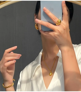 Fashionable gold-plated hollow geometric moon jewelry set worn by a model in soft lighting