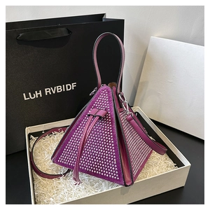 Detail of fuchsia triangle bag with silver rhinestones and drawstring in a gift box