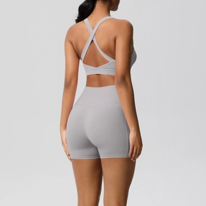 Rear view of grey yoga set featuring criss-cross back sports bra and high-waisted shorts