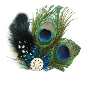 Detailed close-up of peacock feathers and sparkling crystal on women's prom headpiece