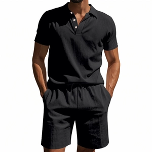 Detail of black linen polo set featuring three-button collar and drawstring waistband
