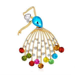 Detail of a gold dancing girl brooch with colorful rhinestones and crystal accents