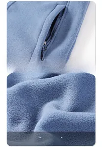 Detail of fleece vest showing side zip pocket and thick plush lining for warmth