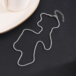Minimalist silver-tone wave chain necklace with adjustable lobster clasp on black background