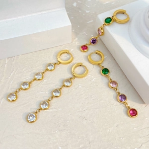 Detailed view of gold tassel earrings featuring clear and colorful zircon gemstones