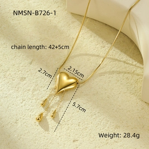 Detailed view of golden heart fringe necklace with measurements and product specifications