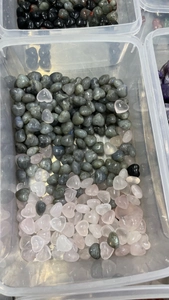 Macro shot of 15mm heart-shaped natural crystal stones including rose quartz and labradorite
