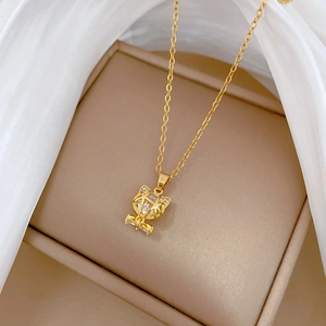 Macro shot of a gold fox pendant with large sparkling crystal on a jewelry box