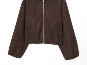 Detail of coffee brown zip-up jacket showing thick textured fabric and metallic zipper