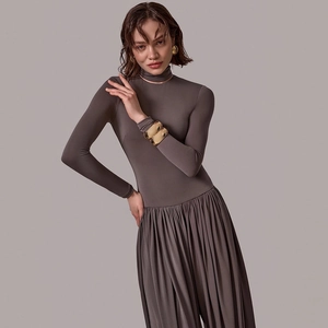 Detail of taupe ruched bodycon dress with side slit and premium stretch fabric