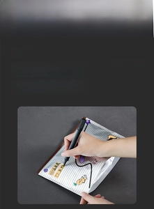 Close-up showing a hand writing labels on an aluminum foil food storage bag for organization