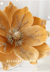 Close-up of golden velvet Christmas magnolia flower with sequins and beaded details