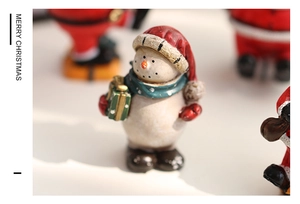 Macro detail of vintage resin snowman figurine with knitted texture and hand-painted finish