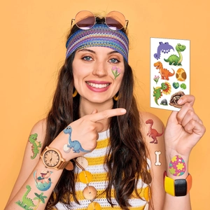 Vibrant cartoon dinosaur temporary tattoos on a model's arm and face for a themed party
