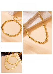 Detail of gold phoenix tail chain jewelry set with necklace and heart pendant