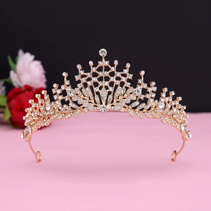 Detailed view of luxury gold bridal crown with crystal leaf patterns and rhinestones
