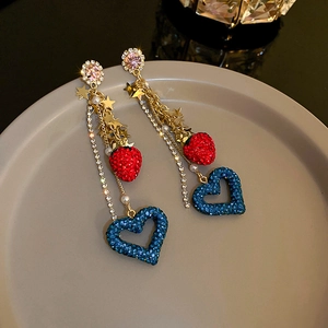 Detail of red strawberry and blue heart rhinestone drop earrings with tassels