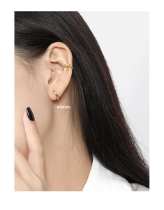 Close-up of 8mm gold minimalist hoop earring and chain cuff on ear with polished finish
